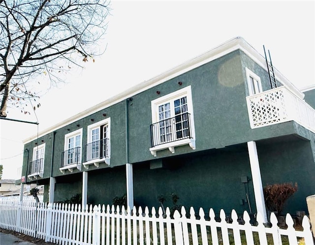 view of side of home with a balcony