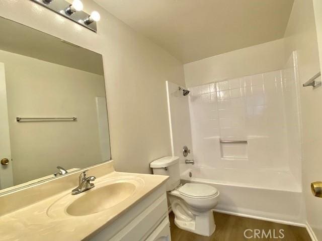 full bathroom featuring toilet, vanity,  shower combination, and hardwood / wood-style flooring