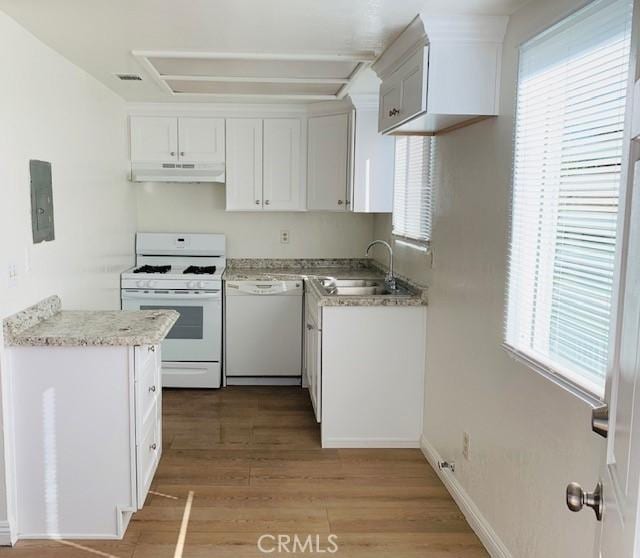 kitchen with white appliances, white cabinetry, sink, plenty of natural light, and light wood-type flooring