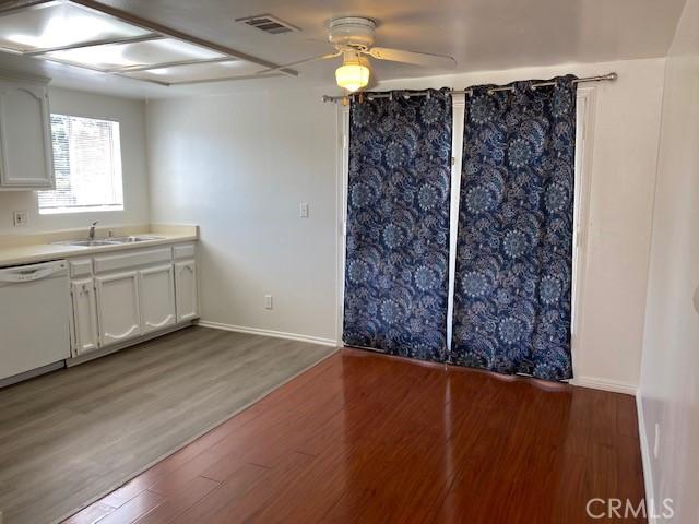 interior space featuring ceiling fan, hardwood / wood-style flooring, and sink