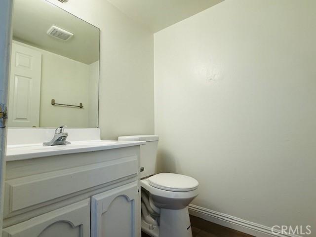 bathroom featuring toilet and vanity