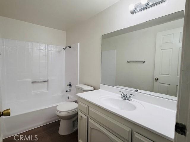 full bathroom with toilet,  shower combination, hardwood / wood-style floors, and vanity