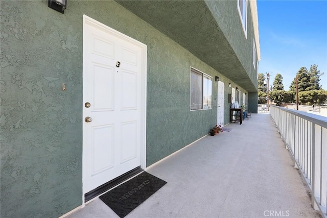entrance to property with stucco siding