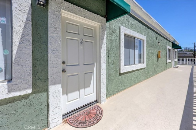 doorway to property with stucco siding