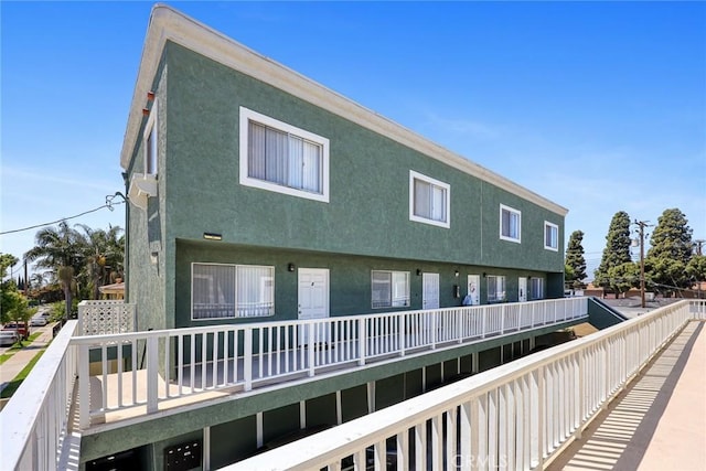 back of property featuring stucco siding