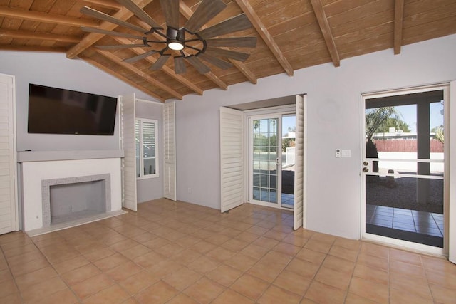 unfurnished living room with wooden ceiling, light tile patterned floors, vaulted ceiling with beams, and a tile fireplace