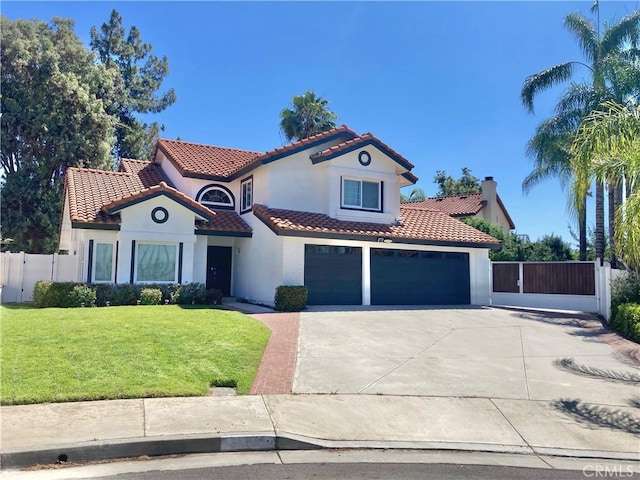 mediterranean / spanish-style house featuring a front yard and a garage