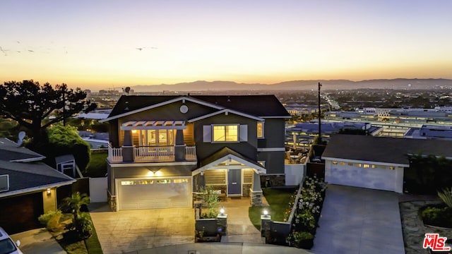 view of front of house with a mountain view and a balcony