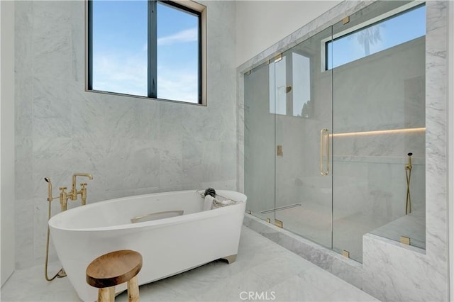 bathroom featuring shower with separate bathtub