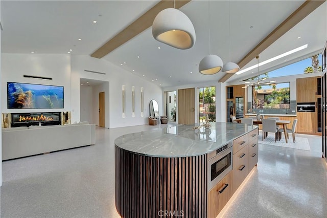 kitchen with a kitchen island, decorative light fixtures, vaulted ceiling with beams, light brown cabinetry, and stainless steel microwave