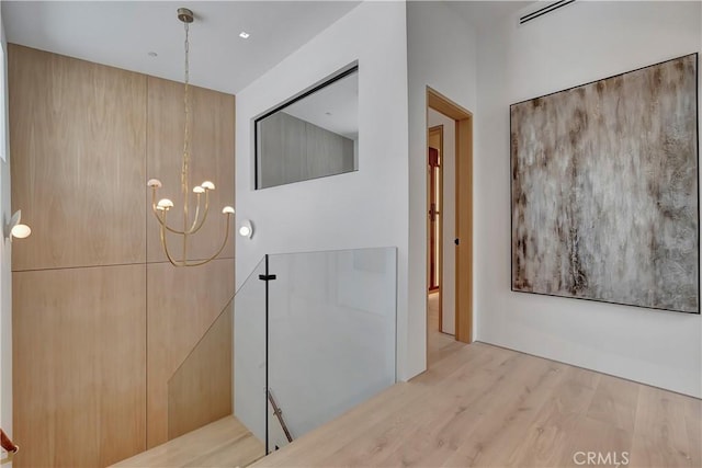 interior space with hardwood / wood-style flooring and a chandelier