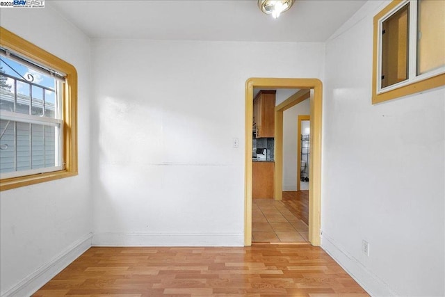 unfurnished room with light wood-type flooring