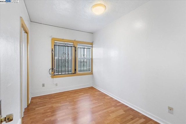 unfurnished room with light wood-type flooring