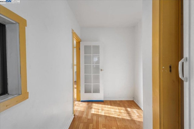 hallway featuring french doors and hardwood / wood-style flooring