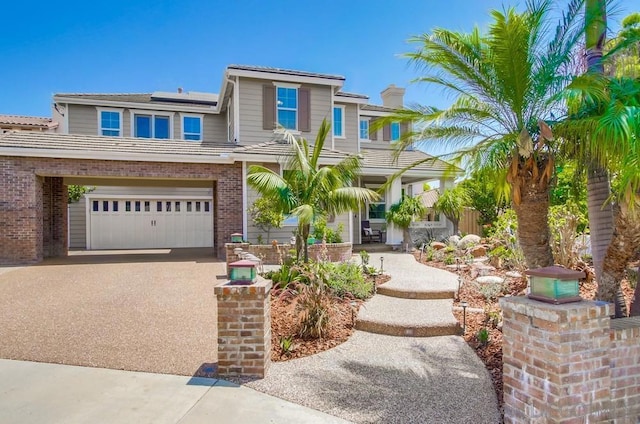 view of front of house featuring solar panels and a garage