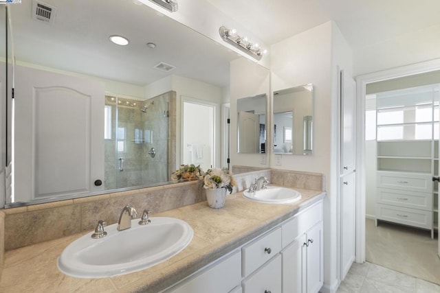 bathroom featuring vanity and an enclosed shower