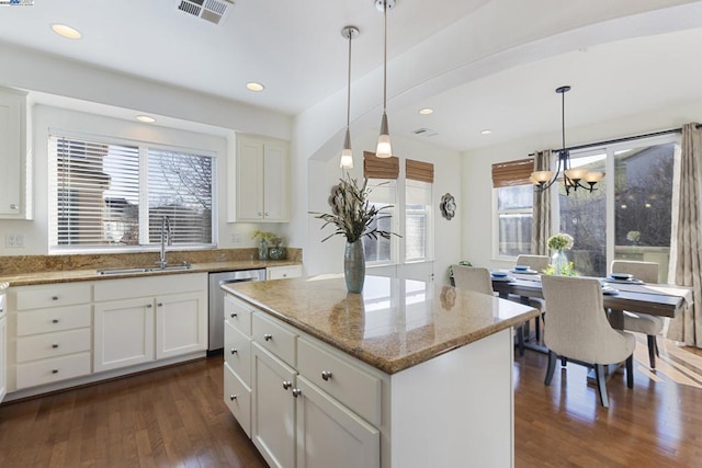 kitchen with a center island, decorative light fixtures, dishwasher, and white cabinets