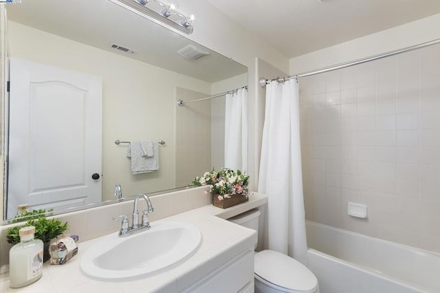 full bathroom featuring shower / tub combo with curtain, vanity, and toilet