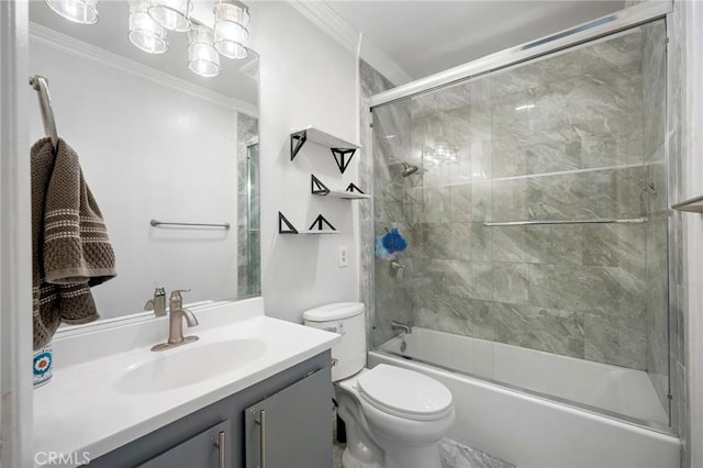 full bathroom with vanity, toilet, bath / shower combo with glass door, and ornamental molding