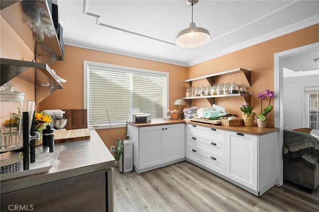 kitchen with ornamental molding, butcher block counters, and open shelves