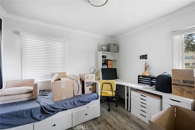 bedroom featuring crown molding and wood finished floors