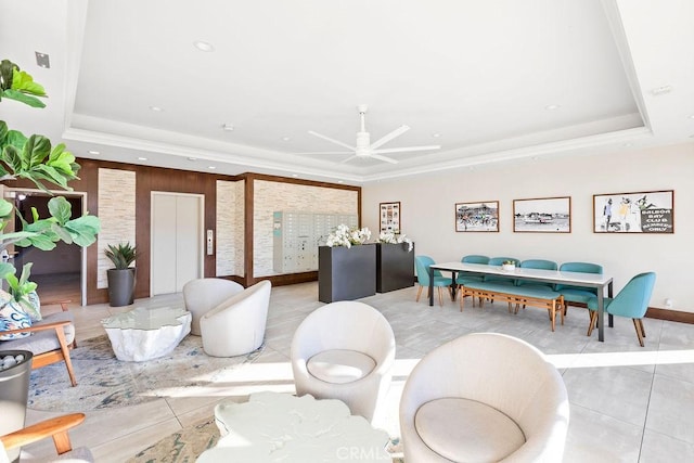 living room with ceiling fan, light tile patterned flooring, a raised ceiling, and elevator