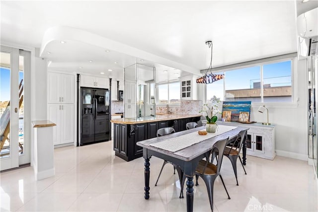 dining room with light tile patterned flooring and sink