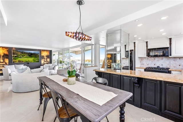 tiled dining room featuring an inviting chandelier