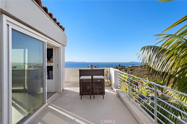 balcony featuring a water view