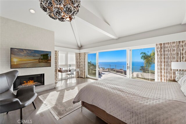 766 Pelican, Laguna Beach, CA 92651 - bedroom with access to exterior, a water view, wood finished floors, a fireplace, and a chandelier
