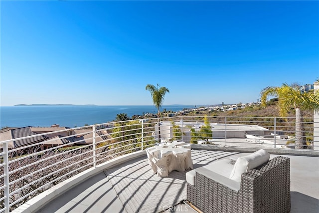 view of patio with a water view and a balcony