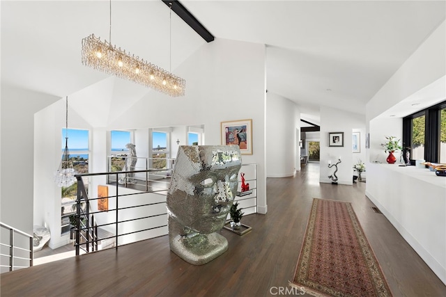 hall with a chandelier, beam ceiling, dark hardwood / wood-style floors, and high vaulted ceiling