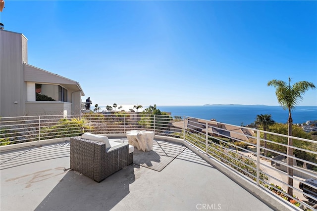 view of patio / terrace featuring a water view and a balcony