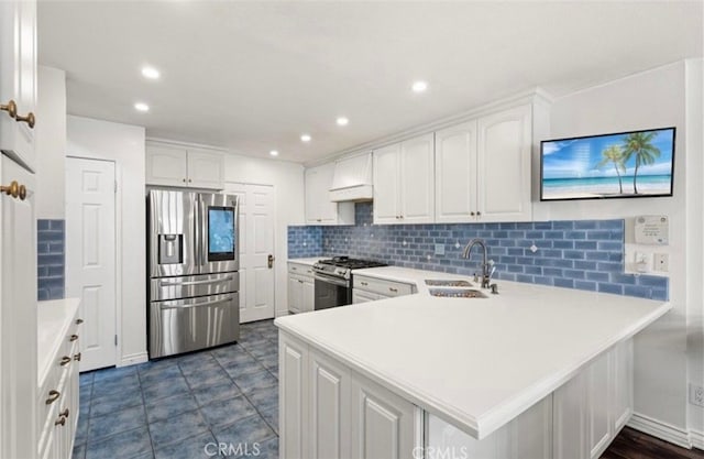 kitchen with stainless steel appliances, white cabinetry, sink, and kitchen peninsula