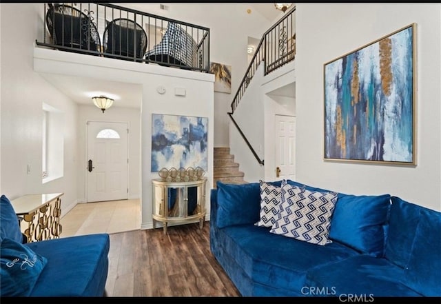 living room with a towering ceiling and hardwood / wood-style floors