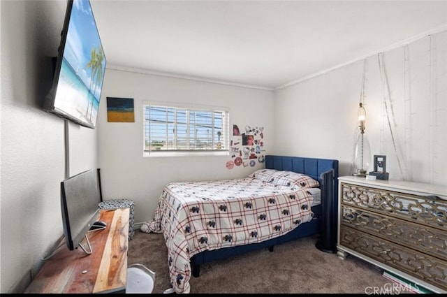 bedroom featuring crown molding and dark colored carpet