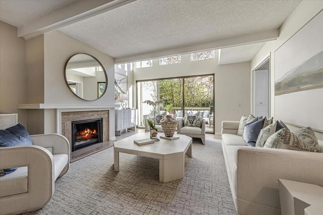 living room featuring beamed ceiling, a fireplace, and a textured ceiling