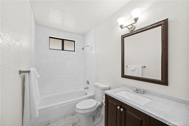 full bathroom featuring toilet, vanity, and tiled shower / bath