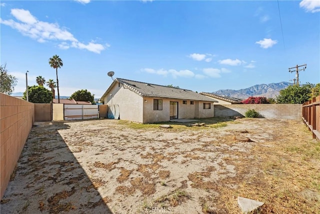 rear view of house featuring a mountain view