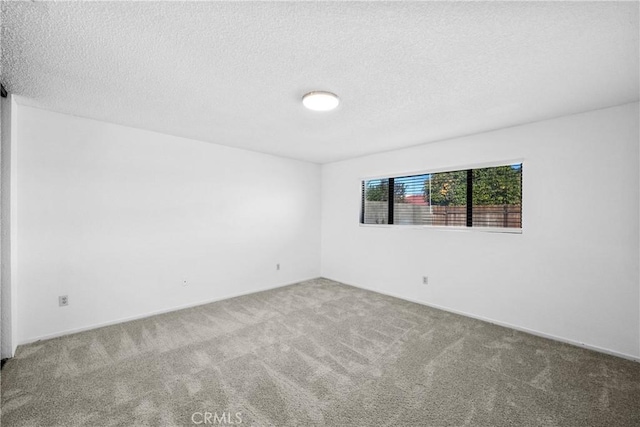 unfurnished room featuring a textured ceiling and carpet floors