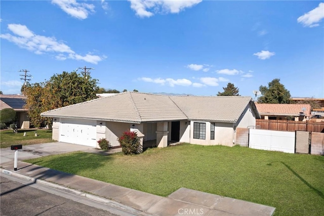 ranch-style house featuring a garage and a front yard