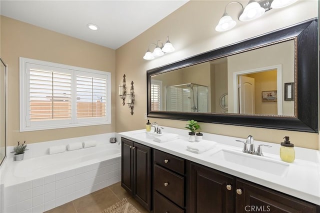 bathroom featuring independent shower and bath, vanity, and tile patterned floors