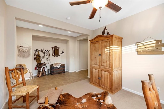 interior space with light colored carpet and ceiling fan