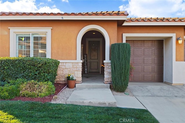 view of exterior entry with a garage