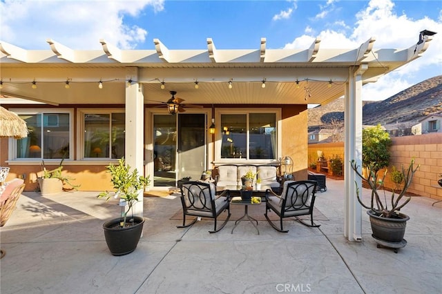 view of patio / terrace featuring a mountain view, an outdoor hangout area, and ceiling fan