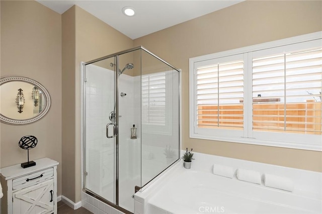 bathroom featuring shower with separate bathtub