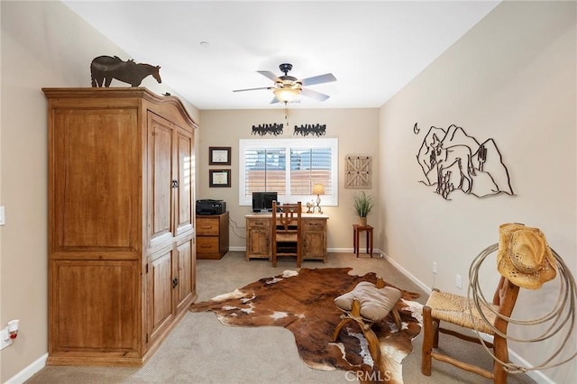 office area with ceiling fan and light carpet