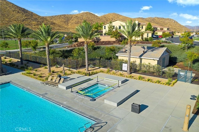 view of pool featuring a mountain view and a patio area