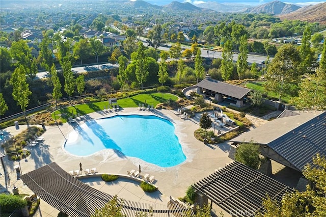 view of swimming pool with a pergola, a mountain view, and a patio area