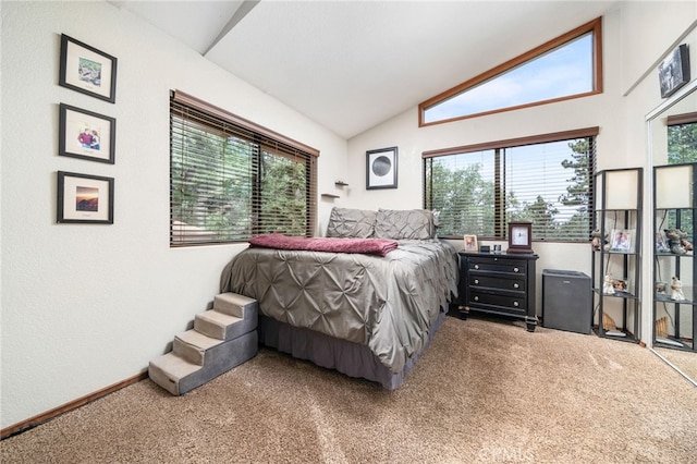 carpeted bedroom featuring lofted ceiling